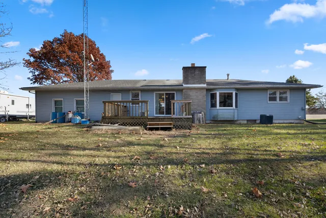 a view of a house with a swimming pool and a yard