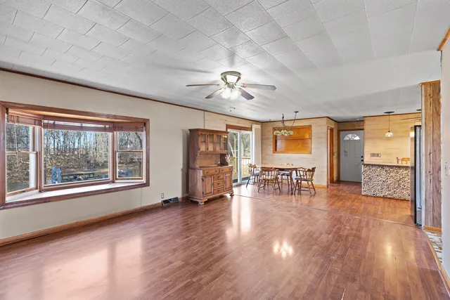 a view of empty room with wooden floor and fireplace