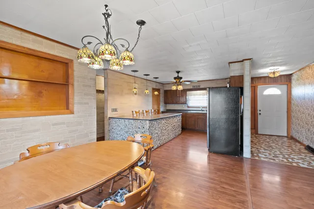 a lobby with a chandelier and wooden floor