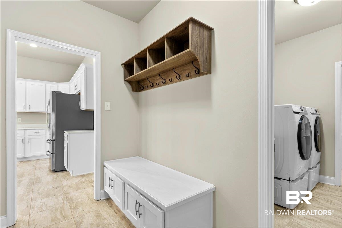 1112 Stella Road Foley, AL 36535 - Photo 11 of 33 Mudroom with washer and dryer and baseboards