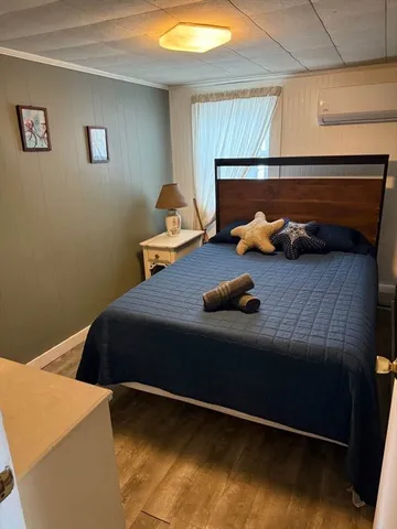 a bed sitting in a bedroom next to a window