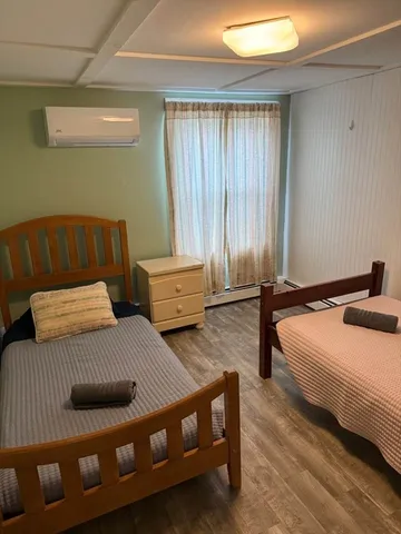 a bedroom with bed and window