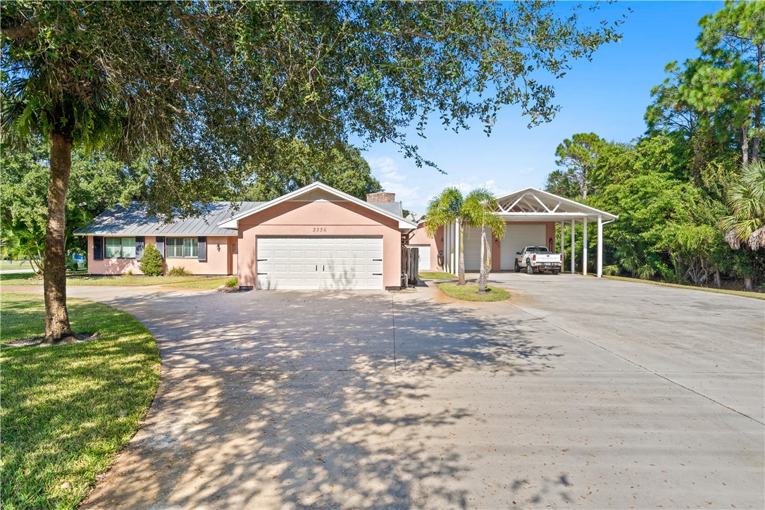 a front view of a house with a yard and trees