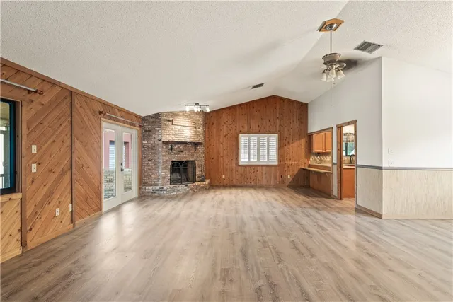 a kitchen with stainless steel appliances granite countertop a refrigerator a sink a stove and island