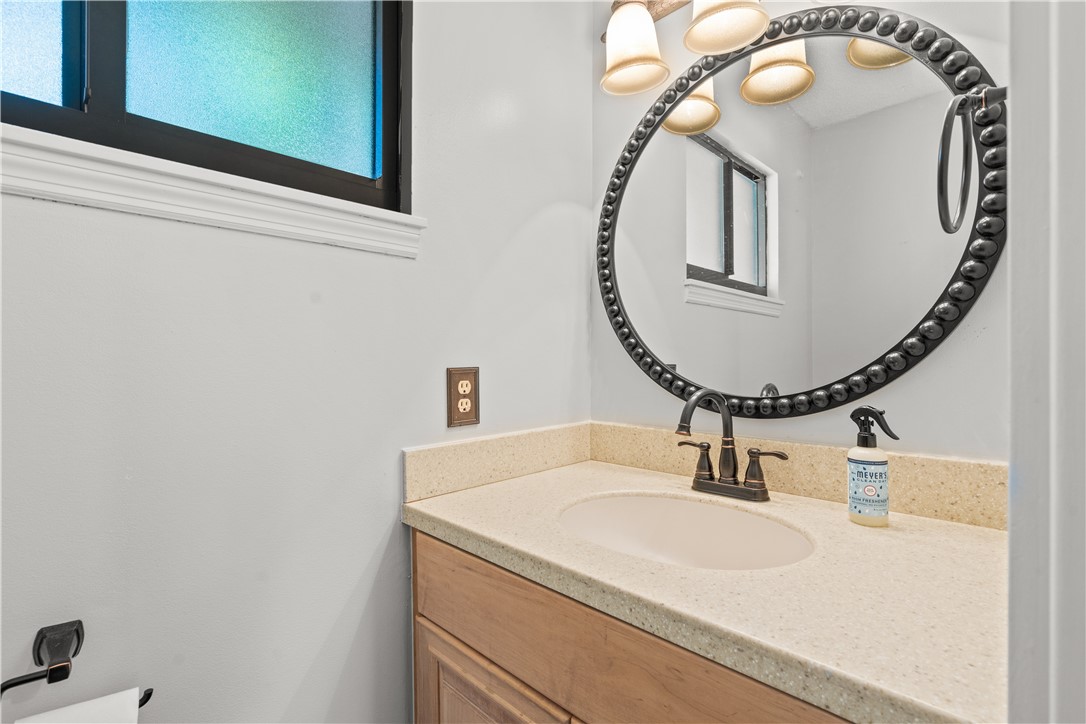 3336 8th Street Vero Beach, FL 32968 - Photo 16 of 36 a bathroom with a sink and a mirror