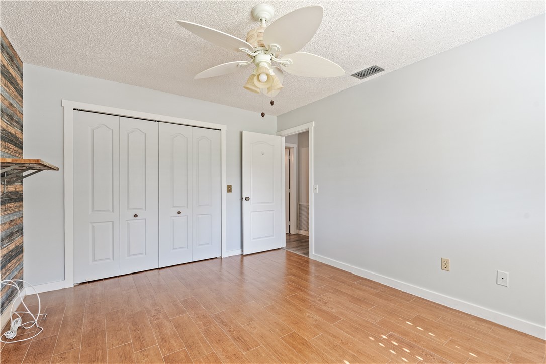 3336 8th Street Vero Beach, FL 32968 - Photo 19 of 36 wooden floor in an empty room with a window