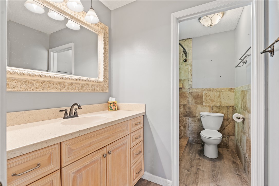 3336 8th Street Vero Beach, FL 32968 - Photo 21 of 36 a bathroom with a sink a toilet and a mirror