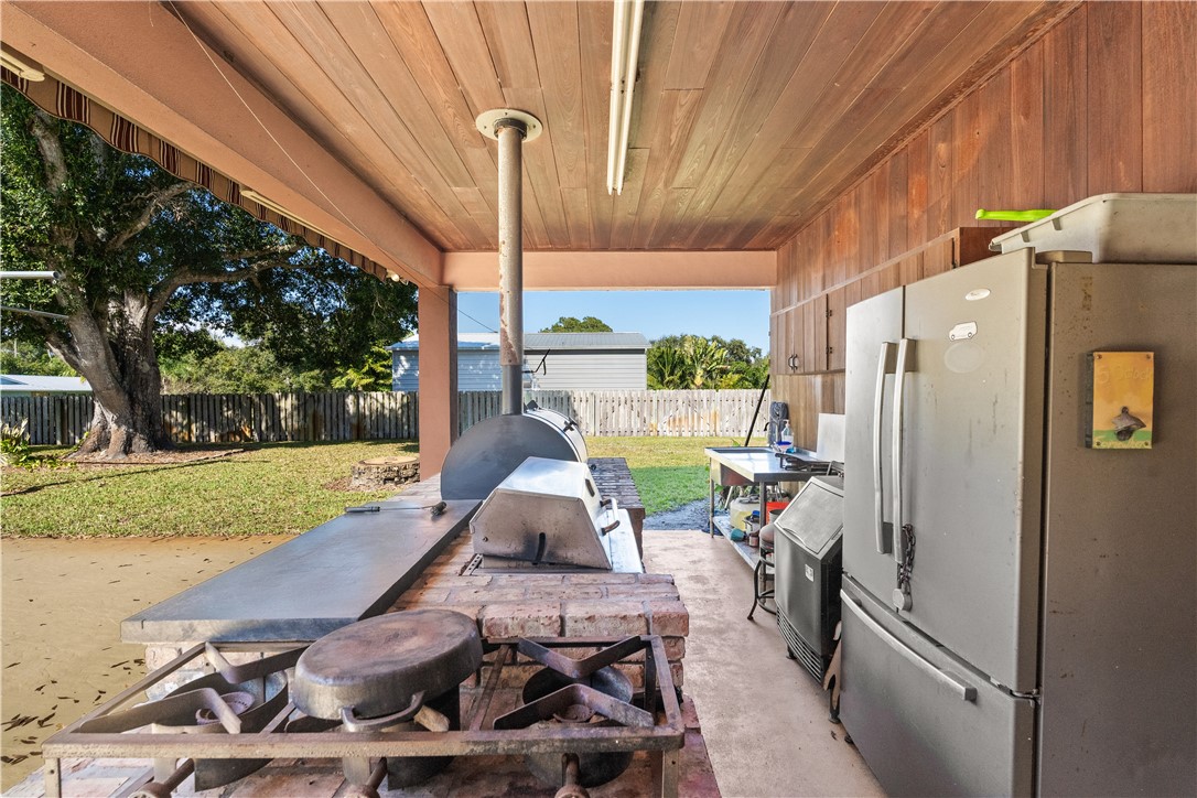 3336 8th Street Vero Beach, FL 32968 - Photo 25 of 36 a patio with table and chairs