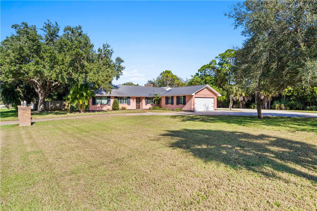 3336 8th Street Vero Beach, FL 32968 - Photo 35 of 36 a house view with swimming pool in front of it