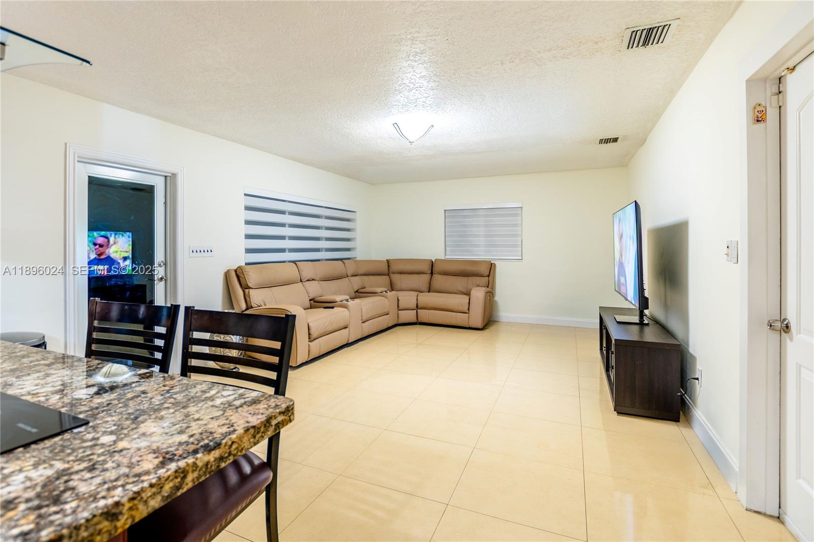 10820 Southwest 125th Street Miami, FL 33176 - Photo 12 of 46 a bedroom with furniture and a flat screen tv