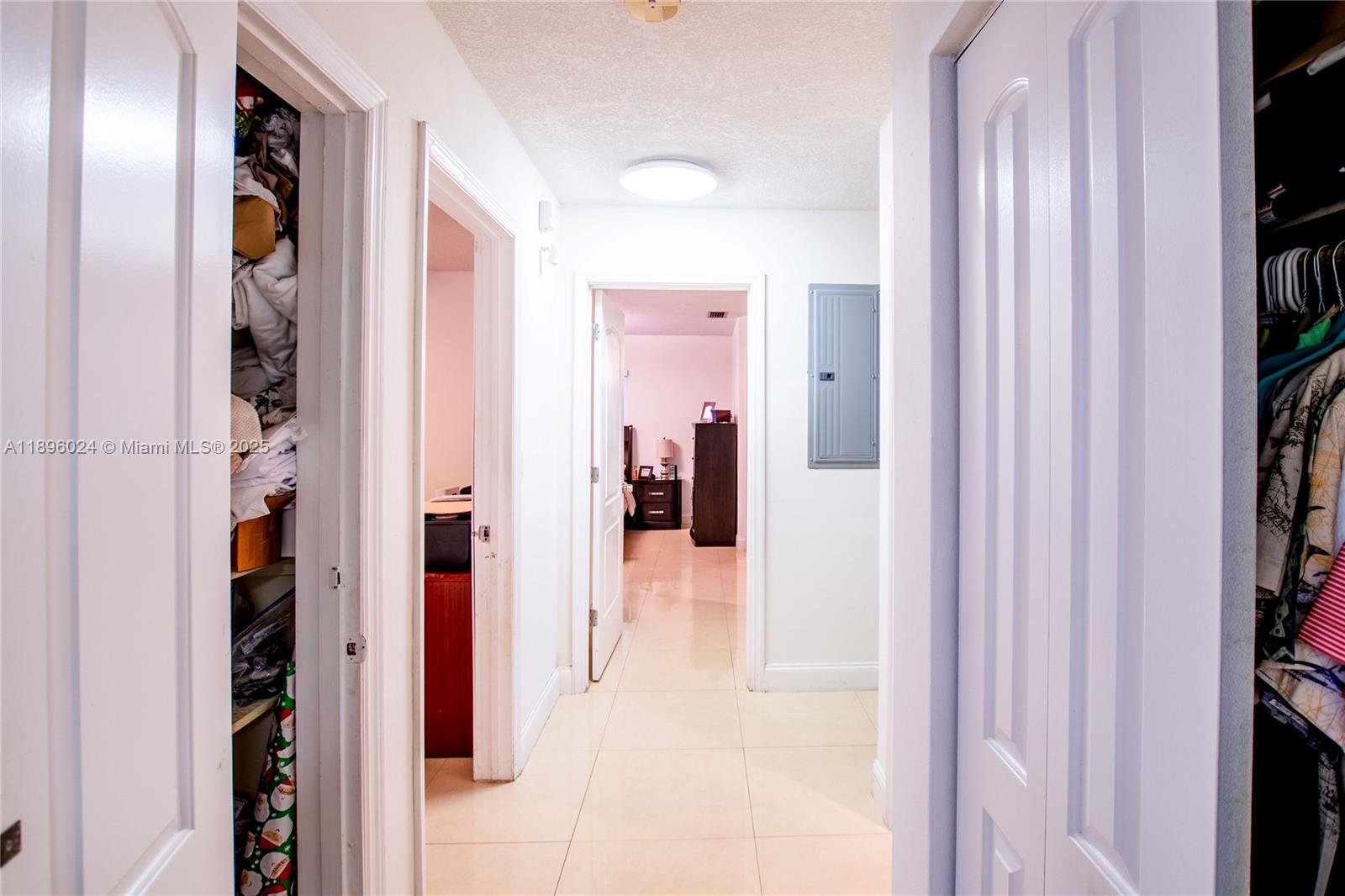 10820 Southwest 125th Street Miami, FL 33176 - Photo 16 of 46 a hallway with closet and a large mirror