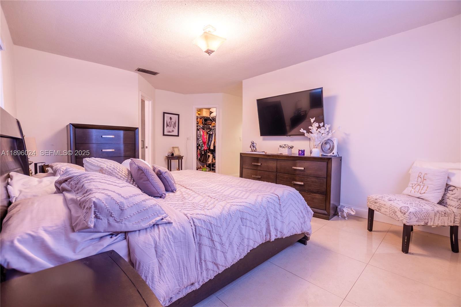 10820 Southwest 125th Street Miami, FL 33176 - Photo 18 of 46 a bedroom with a bed and a flat screen tv
