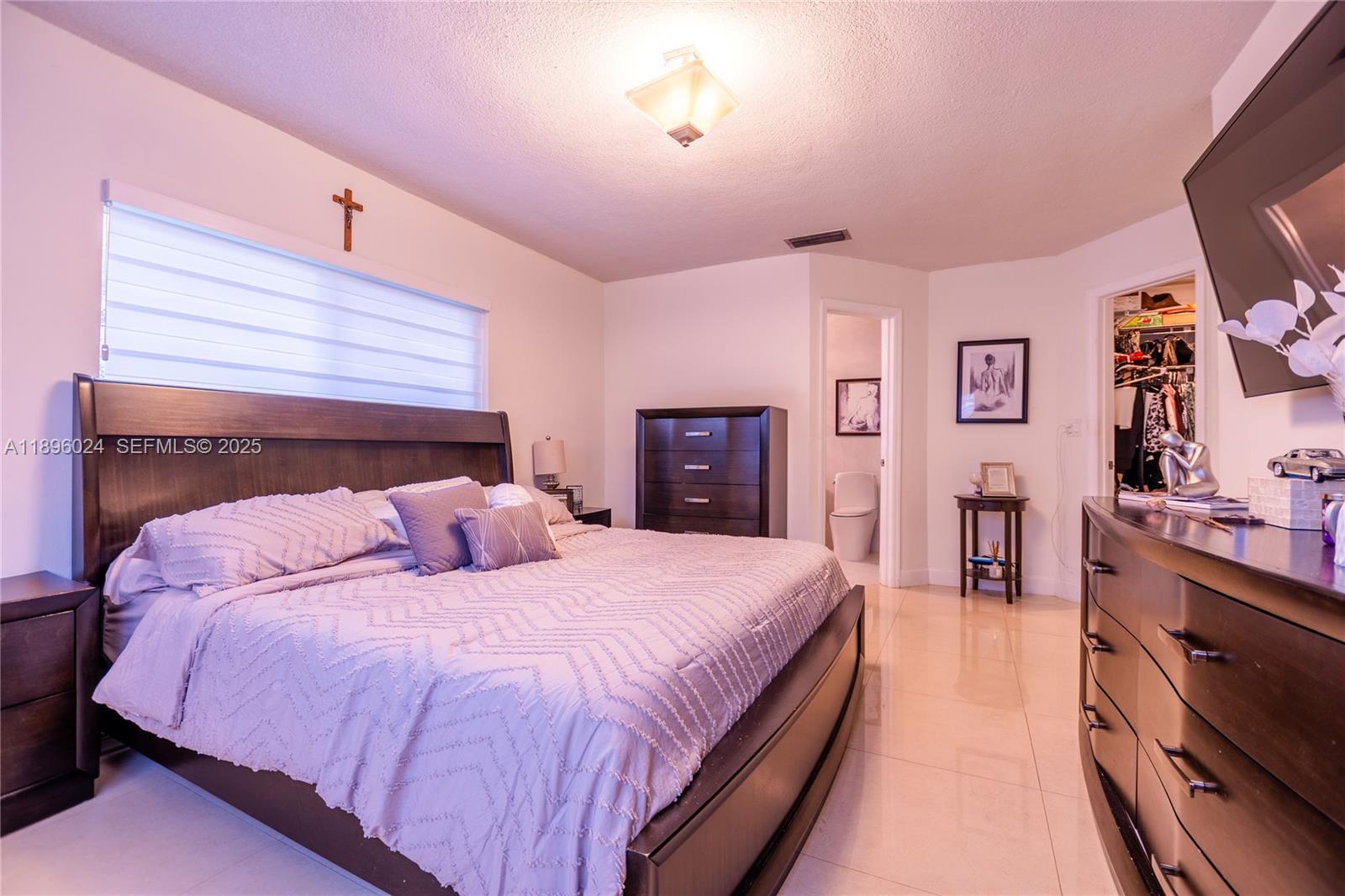 10820 Southwest 125th Street Miami, FL 33176 - Photo 19 of 46 a bed room with a bed and a television