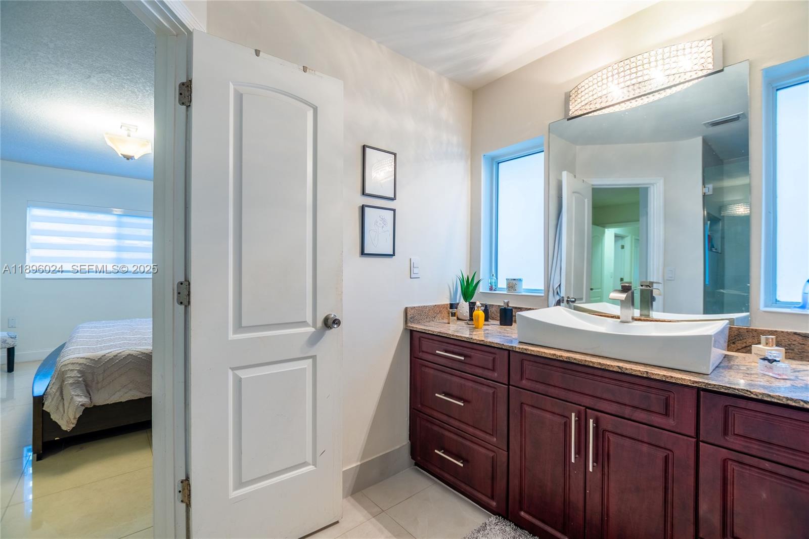 10820 Southwest 125th Street Miami, FL 33176 - Photo 24 of 46 a en suite bathroom with a sink and a mirror