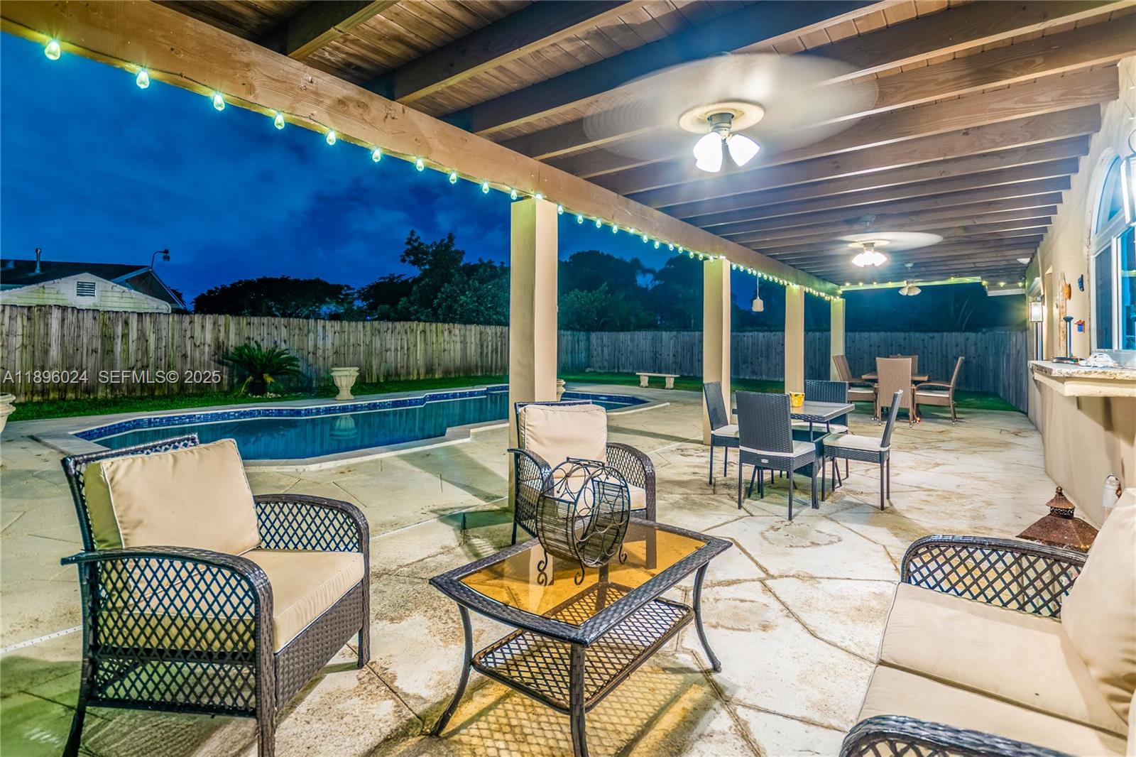 10820 Southwest 125th Street Miami, FL 33176 - Photo 35 of 46 a view of a patio with a table chairs and a patio