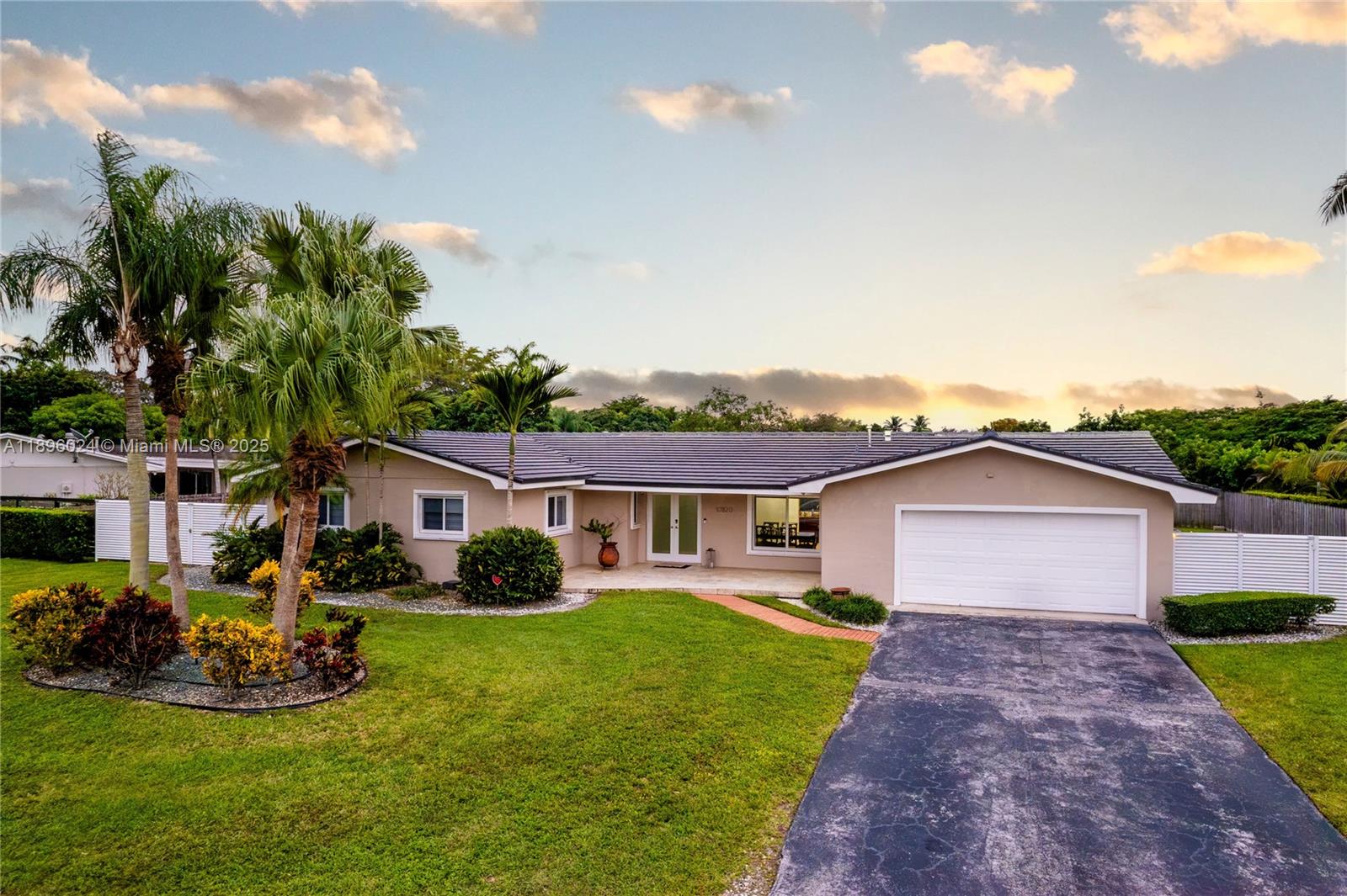 10820 Southwest 125th Street Miami, FL 33176 - Photo 42 of 46 a front view of a house with garden
