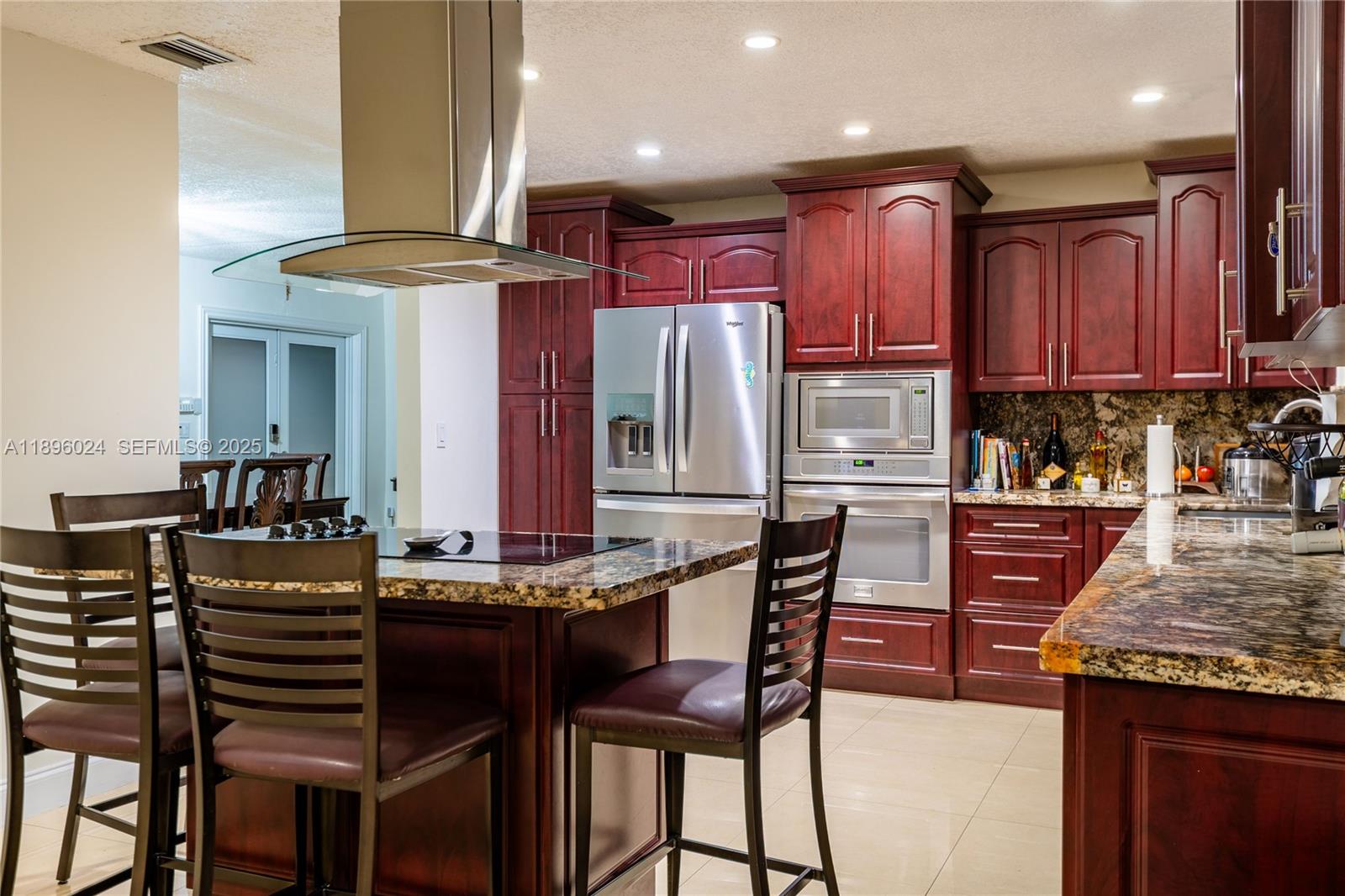 10820 Southwest 125th Street Miami, FL 33176 - Photo 8 of 46 a kitchen with stainless steel appliances granite countertop a stove top oven a sink and a refrigerator