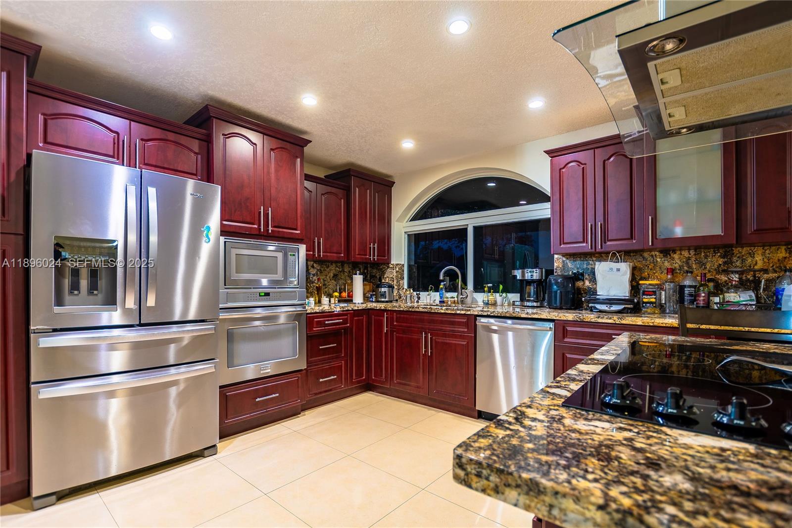 10820 Southwest 125th Street Miami, FL 33176 - Photo 9 of 46 a kitchen with granite countertop stainless steel appliances and wooden cabinets