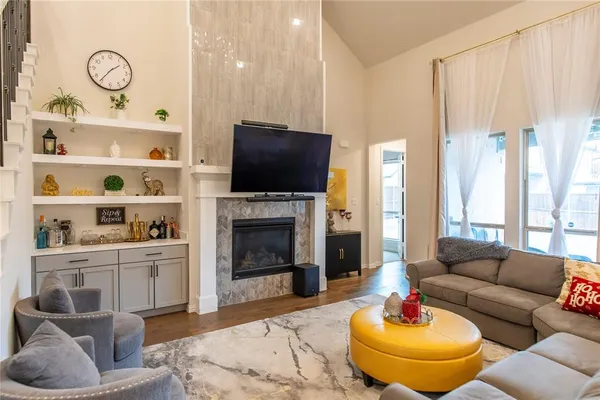 a living room with furniture a flat screen tv and a fireplace