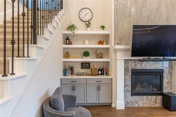 a living room with fireplace furniture and a flat screen tv
