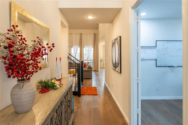 a hallway with flowers and wooden floor