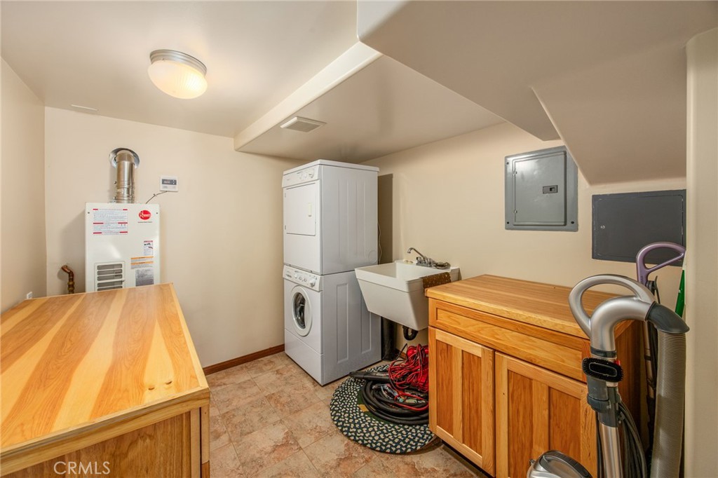 1134 Scenic Way Rimforest, CA 92378 - Photo 18 of 37 Indoor Laundry Room with Utility Sink, Storage, Folding Surface and TANKLESS Water Heater