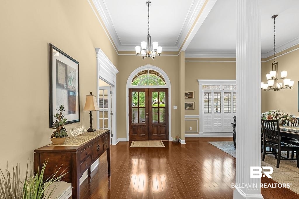 29976 Dolive Ridge Daphne, AL 36527 - Photo 8 of 58 Foyer featuring a notable chandelier, ornamental molding, french doors, and dark wood-type flooring