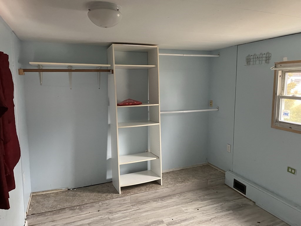 39 Mobile Home Way Springfield, MA 01119 - Photo 5 of 11 a view of an empty room with wooden floor and a window