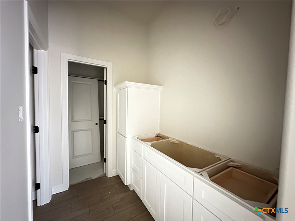 643 Bald Eagle Loop Salado, TX 76571 - Photo 14 of 20 a kitchen with a sink and refrigerator