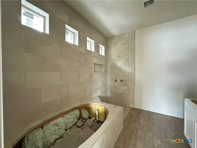 a bathroom with a bathtub and shower