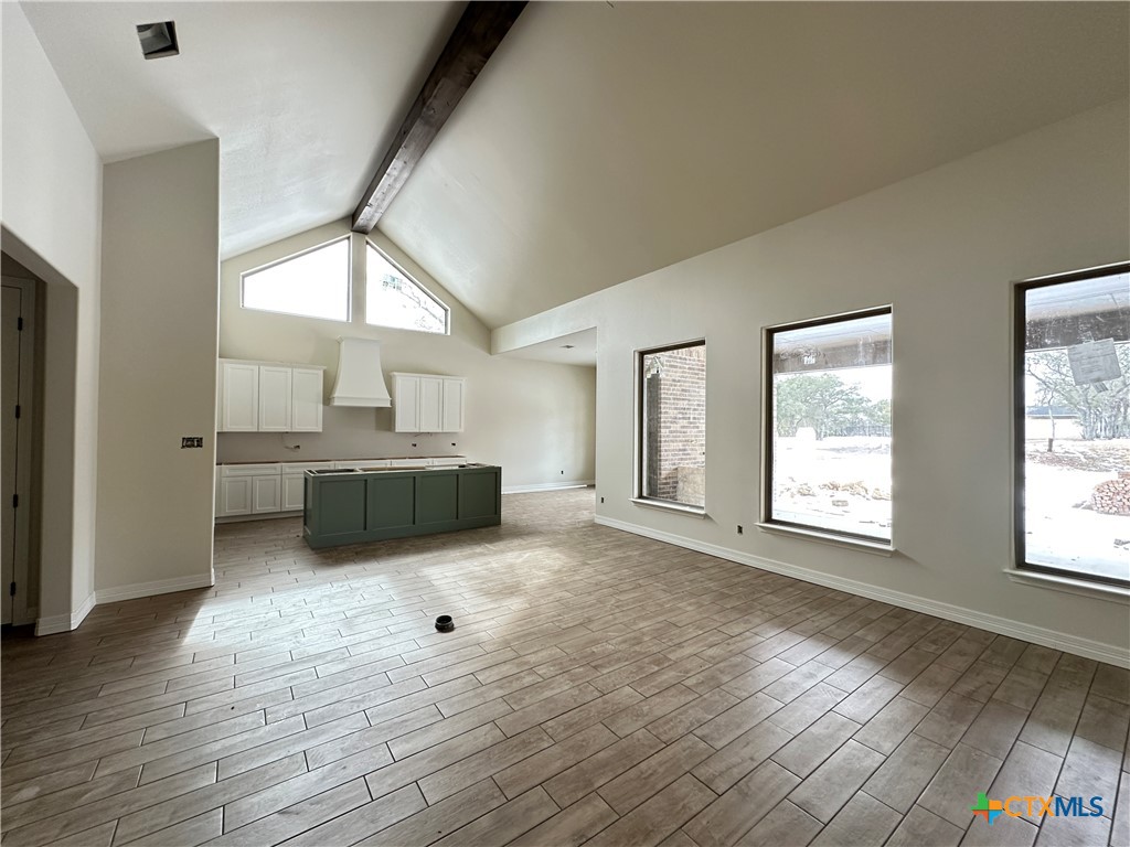 643 Bald Eagle Loop Salado, TX 76571 - Photo 3 of 20 a view of an empty room with a window and wooden floor