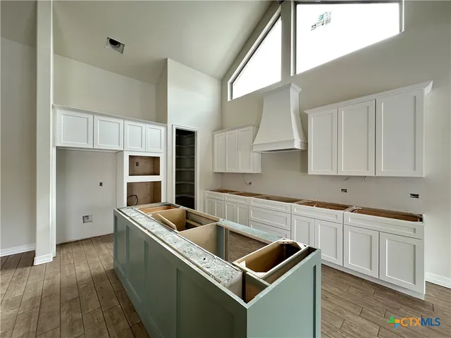 a kitchen that has a sink and a stove in it