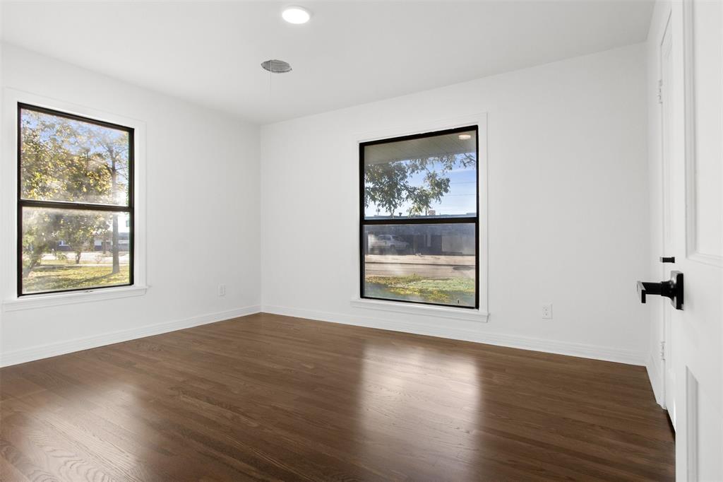 113 West State Street Garland, TX 75040 - Photo 25 of 31 a view of an empty room with wooden floor and a window