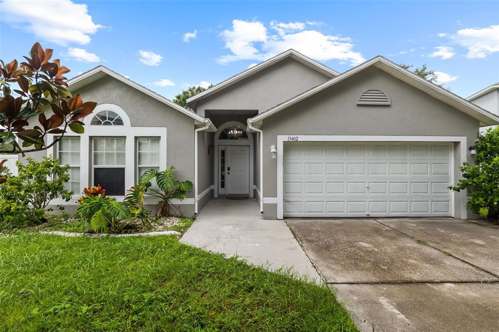 a front view of a house with a yard and garage