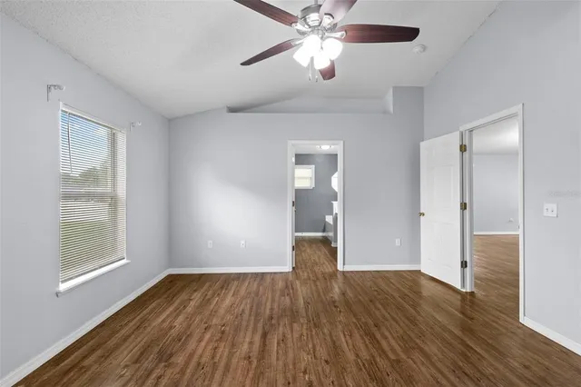 a spacious bathroom with a granite countertop sink a mirror and shower