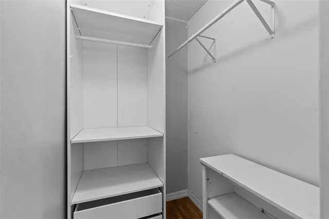 an aerial view of a house with a garden and lake view