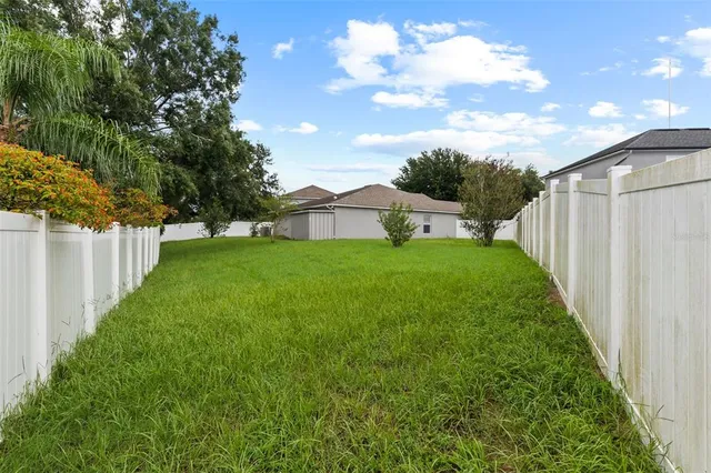 an aerial view of residential houses with outdoor space and swimming pool