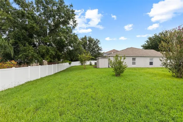 an aerial view of residential houses with outdoor space and river
