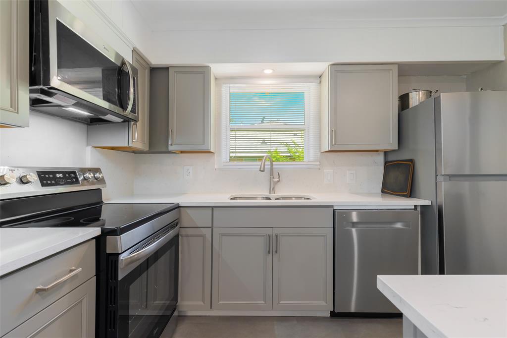 804 Haggard Street Plano, TX 75074 - Photo 12 of 40 a kitchen with stainless steel appliances a sink cabinets and a refrigerator