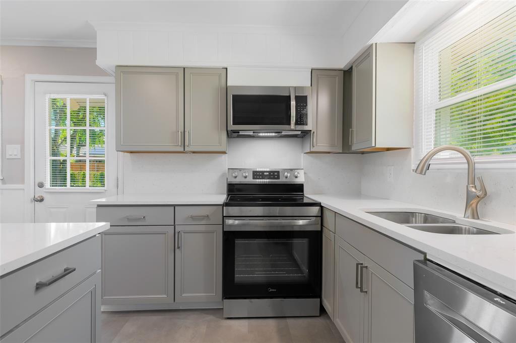804 Haggard Street Plano, TX 75074 - Photo 13 of 40 a kitchen with white cabinets appliances and a sink
