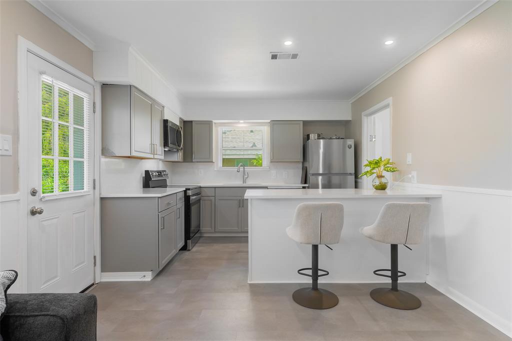 804 Haggard Street Plano, TX 75074 - Photo 15 of 40 a kitchen with a sink cabinets and window