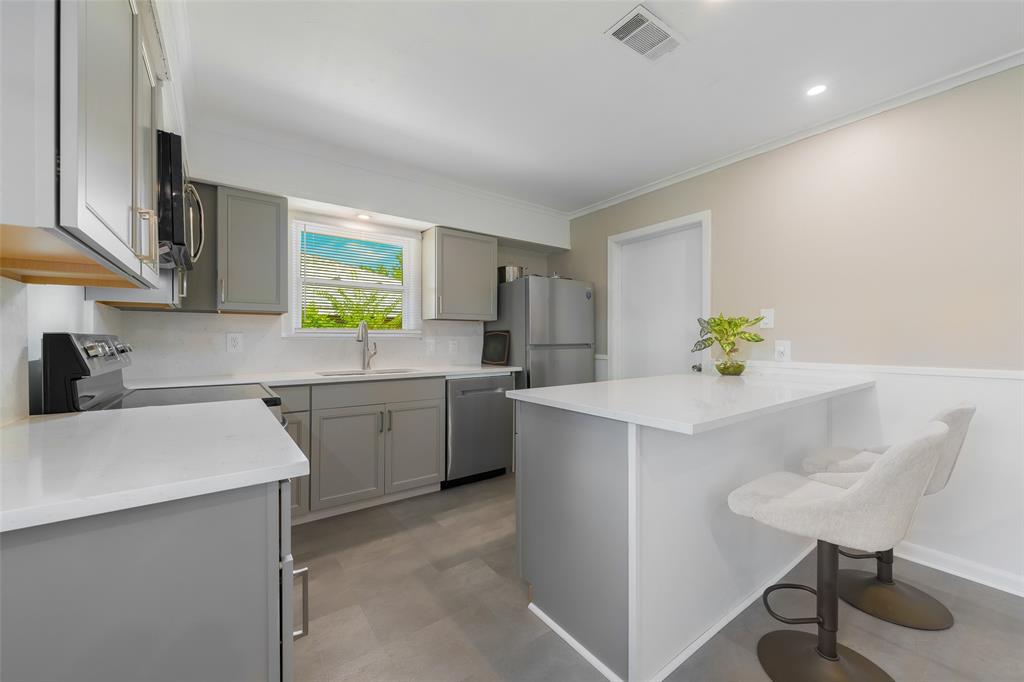 804 Haggard Street Plano, TX 75074 - Photo 17 of 40 a kitchen with a sink cabinets and window