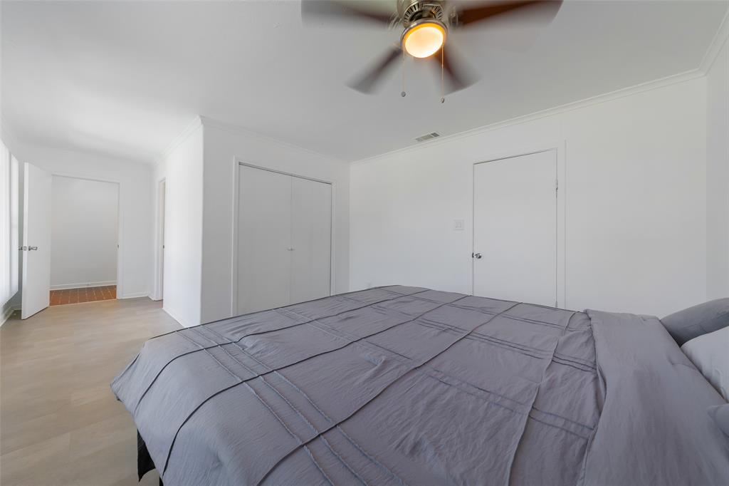 804 Haggard Street Plano, TX 75074 - Photo 20 of 40 a bedroom with a bed and a table