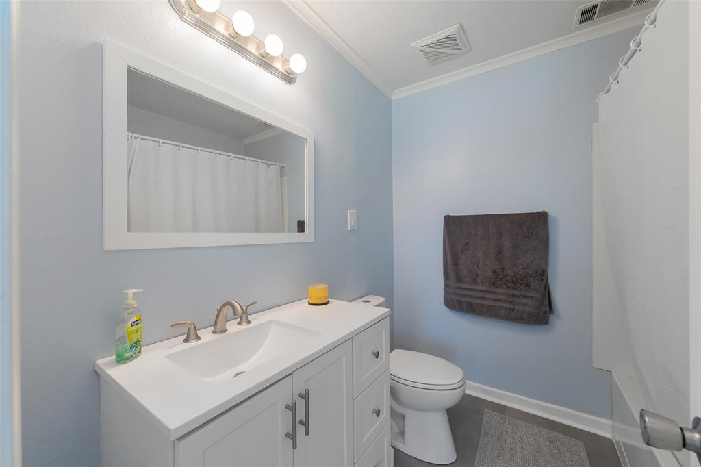 804 Haggard Street Plano, TX 75074 - Photo 22 of 40 a bathroom with a toilet sink vanity and mirror