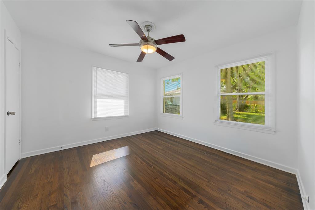804 Haggard Street Plano, TX 75074 - Photo 24 of 40 a view of an empty room with wooden floor and a window