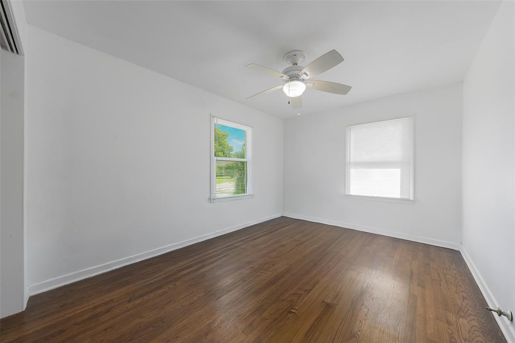 804 Haggard Street Plano, TX 75074 - Photo 25 of 40 a view of an empty room with wooden floor and a window