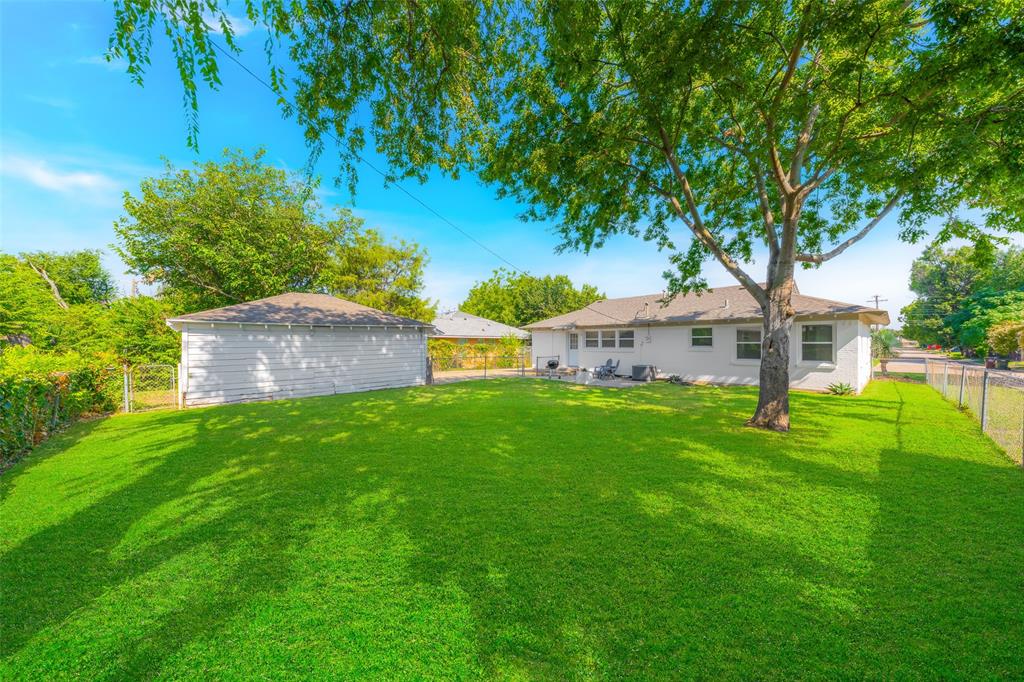 804 Haggard Street Plano, TX 75074 - Photo 30 of 40 a view of a house with a yard and a large tree