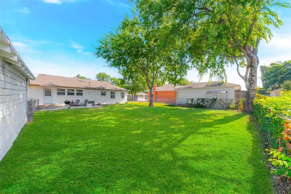804 Haggard Street Plano, TX 75074 - Photo 32 of 40 a view of a house with a big yard and large trees