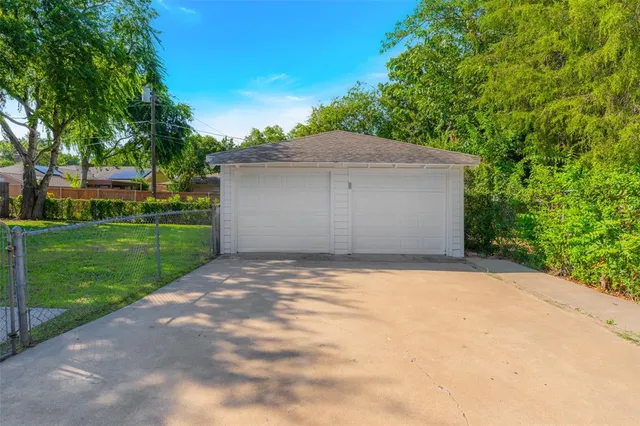 a view of a house with a yard and garage