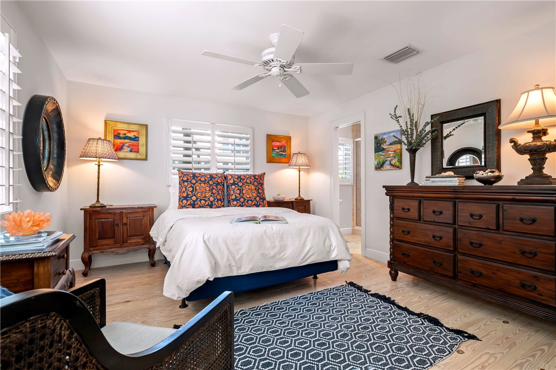 9490 Doubloon Drive Vero Beach, FL 32963 - Photo 23 of 35 a bedroom with a bed and dresser
